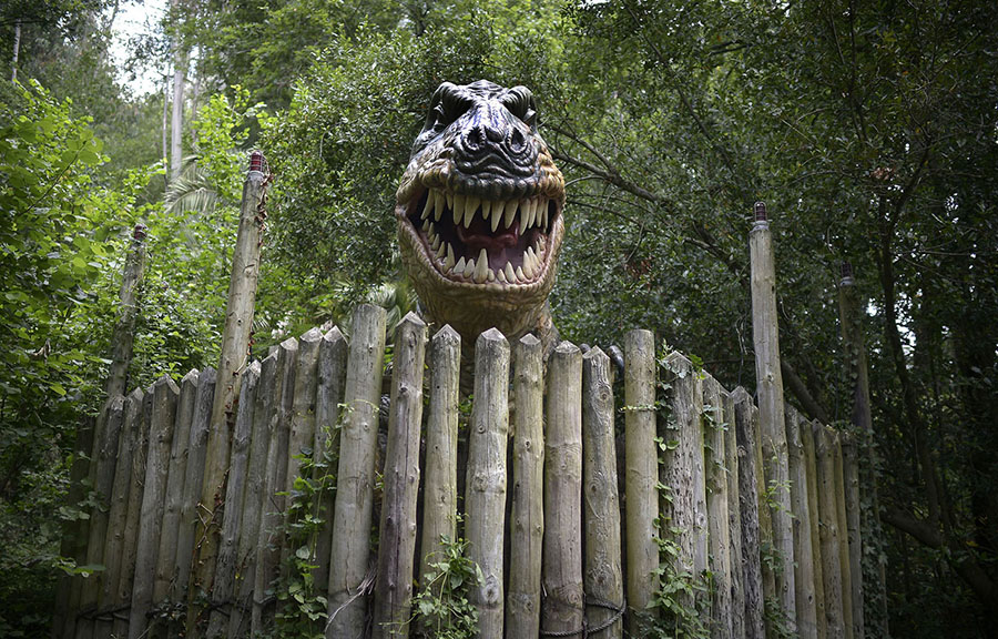 A large model inspired by a Tyrannosaurus rex bares its teeth at the Karpin Abentura park in the Karrantza valley, Spain, on July 26, 2014. #  Vincent West / Reuters