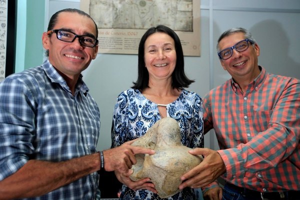 The team of paleontologists with a sloth fossil bone