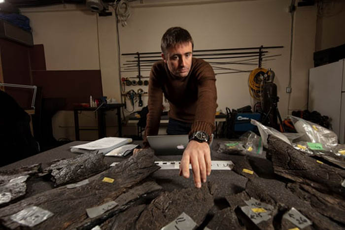 Dr Erich Fitzgerald counts the pieces of the frill of the triceratops. Photograph: John Broomfield/Museums Victoria