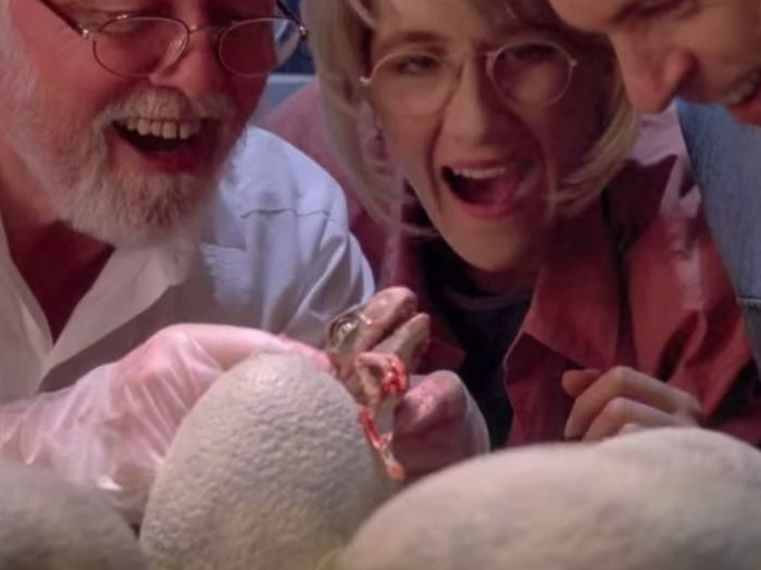 Three characters in "Jurassic Park" observe a velociraptor being born. Universal via YouTube