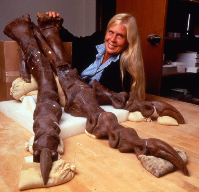 Sue Hendrickson, who discovered Sue the T. rex, poses with one foot of her supersized dino
